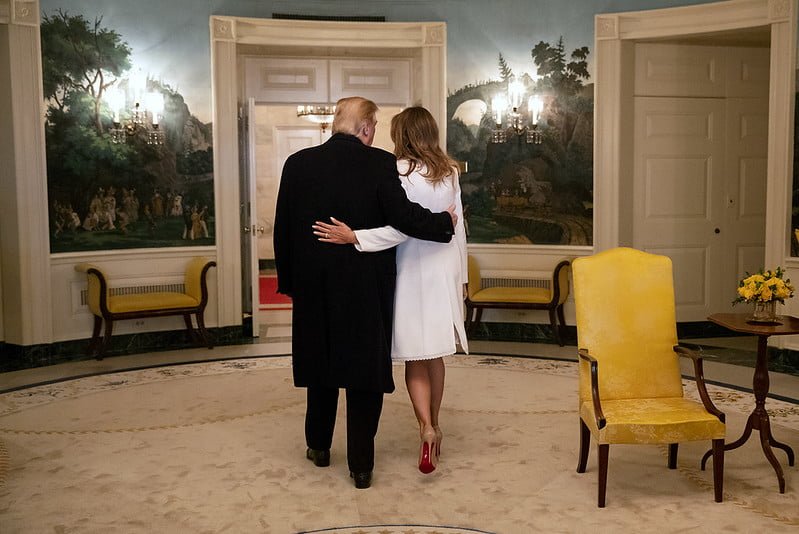 Donald Trump with arm around Melania in the Oval Office from behind