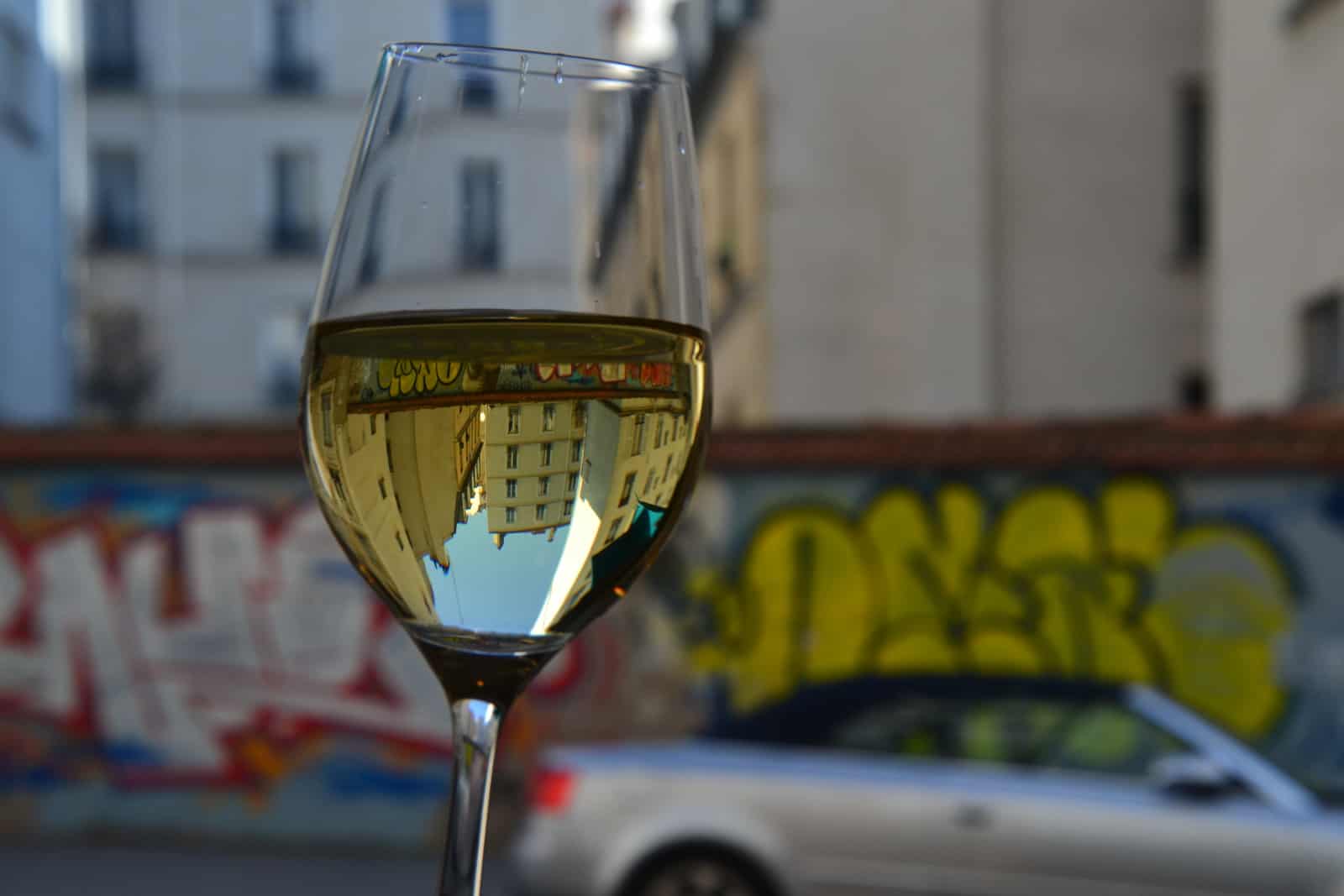 Wine glass with reflection of buildings