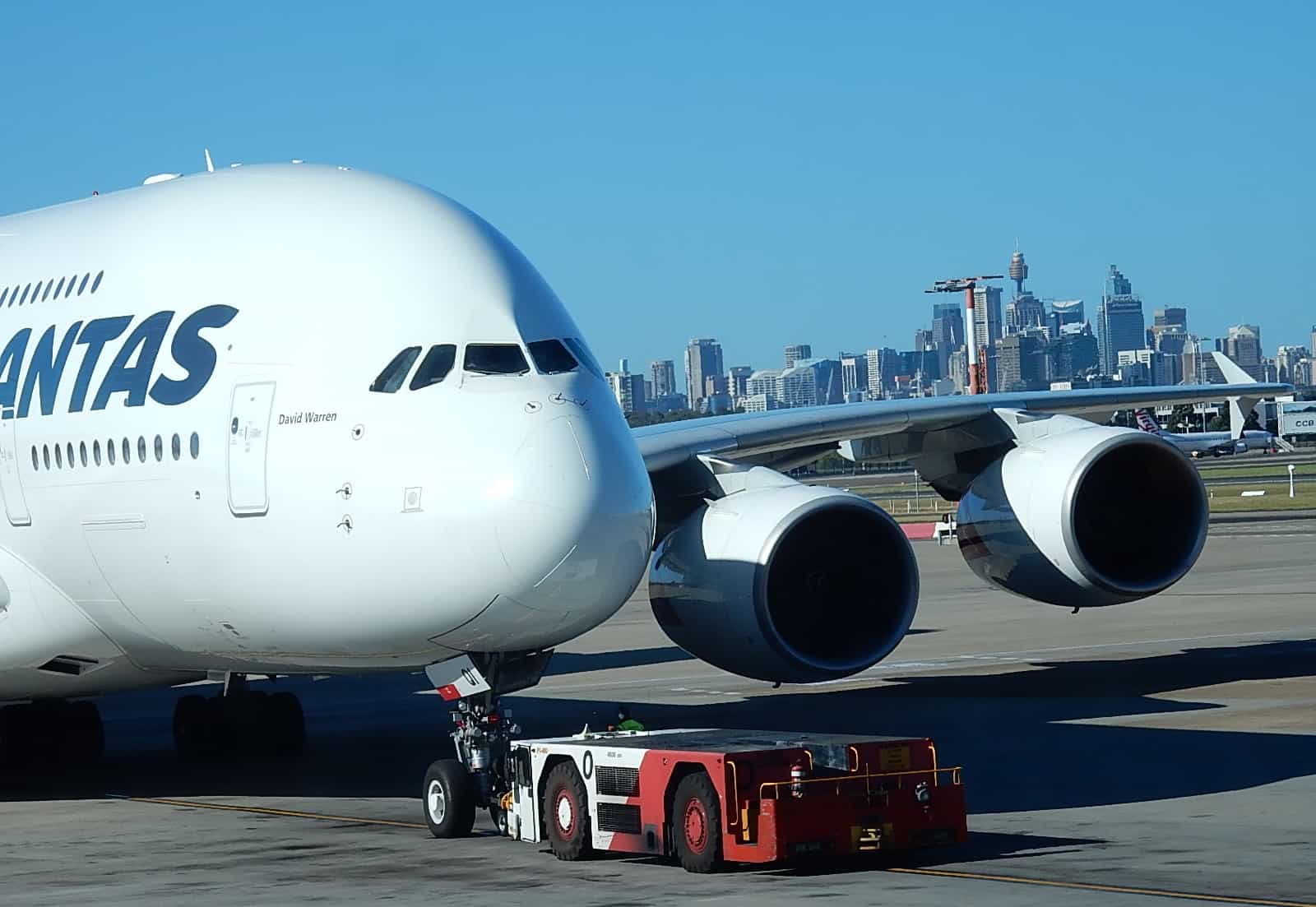 A380 jumbo on runway with city in background
